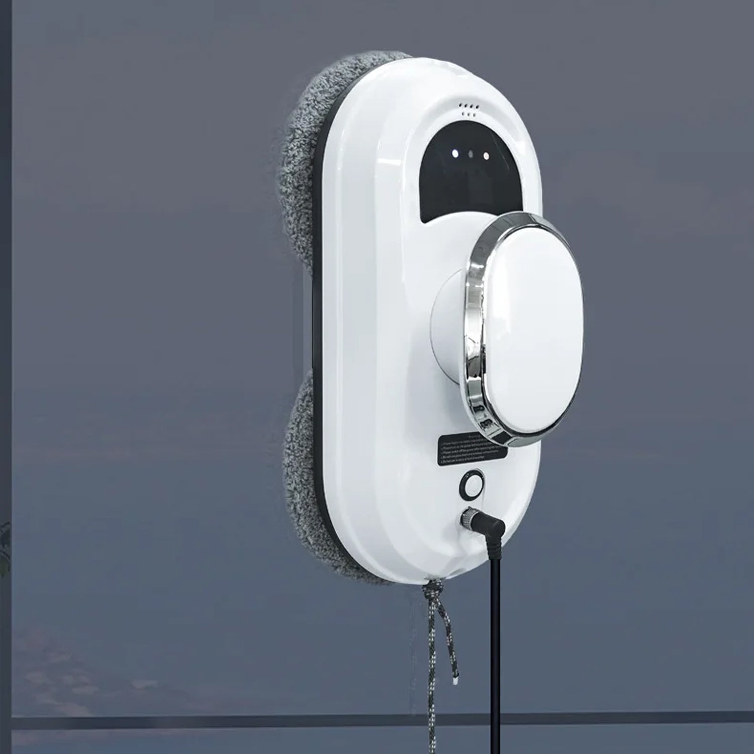 White WinoBotto Robot Window Cleaner with a cord on a dark gray background