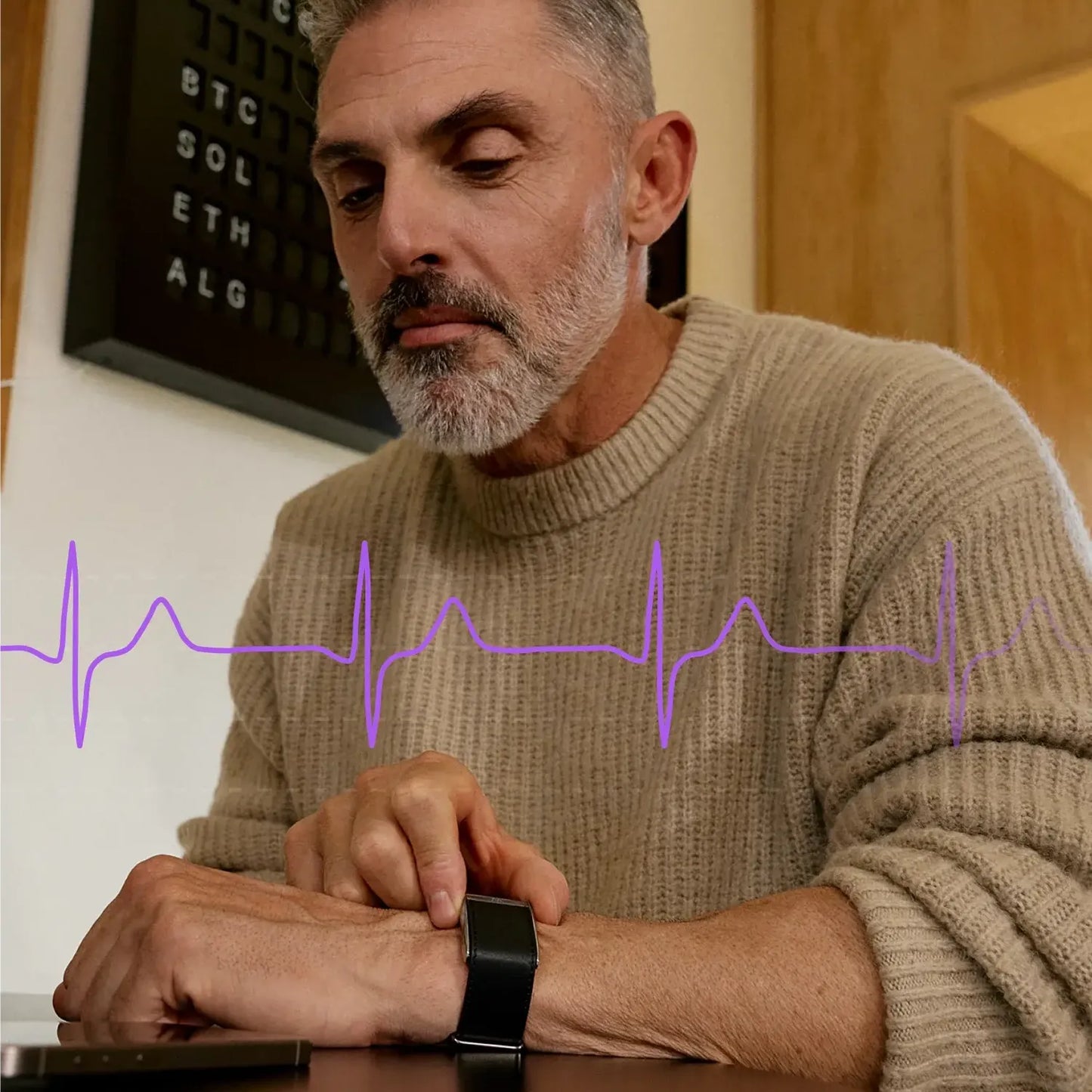 Man using a Yondaly Health Tracker Smart Bands with a heart rate line graphic overlay, sitting at a desk.