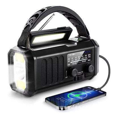 Multifunctional crankoax radio with flashlight, radio, and phone charging capabilities on a white background