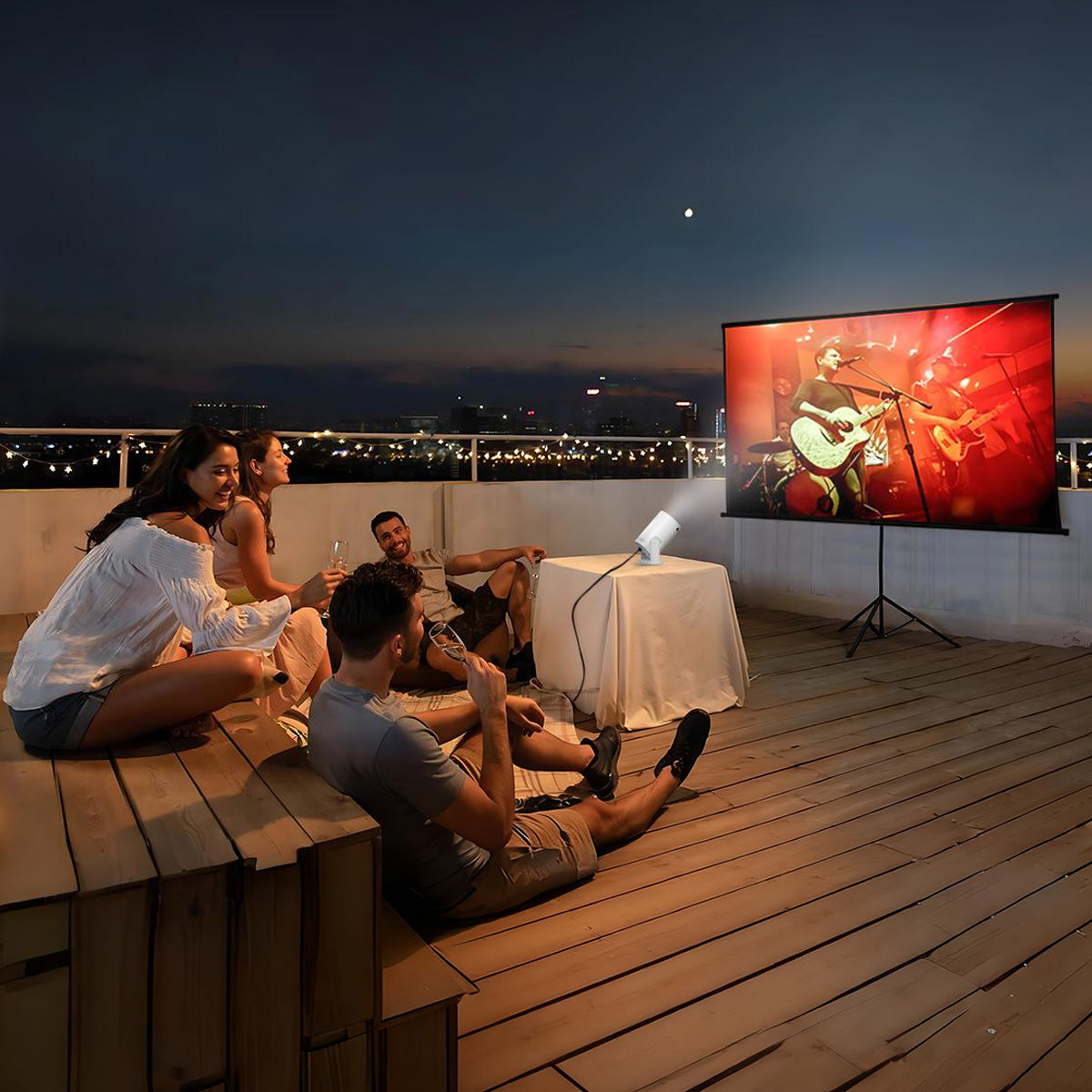 People watching a movie on a screen Smaven Mini Portable Projector onto a wall at night.