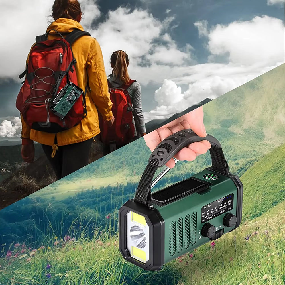 Handheld green and black Handheld with flashlight and radio features, shown outdoors with hikers in the background.