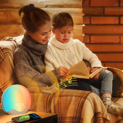 Woman and child reading a book together on a couch with a colorful light Swiftgrid LED Sunrise Alarm Clock on a table.