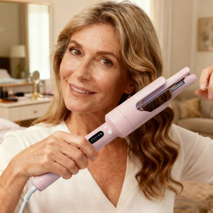 Woman using a pink Aeqis Automatic Rotating Curling Iron in a home setting
