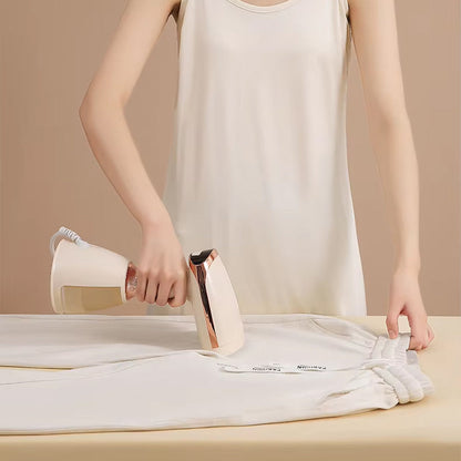 Person ironing a white shirt on a beige surface with a neutral background