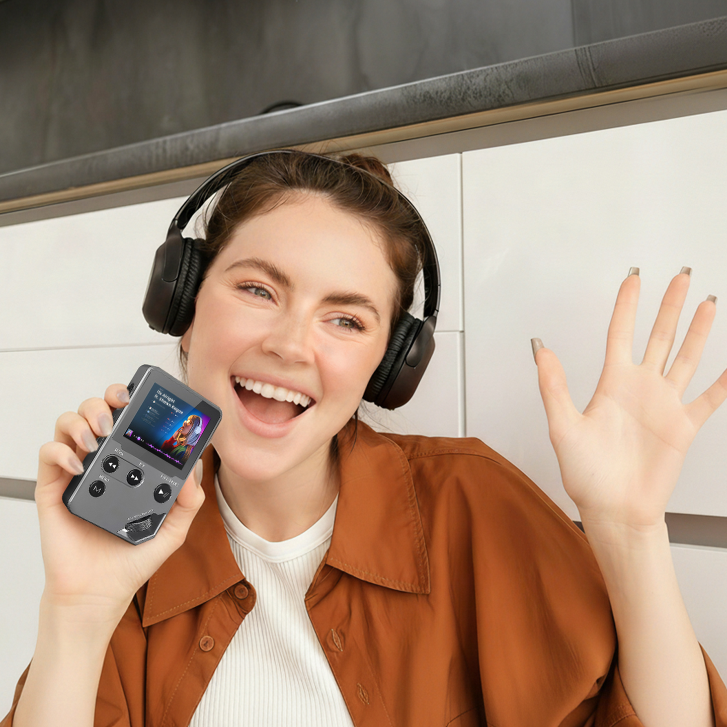 Person wearing headphones and holding a portable Swiftgrid MP3 Player, smiling.