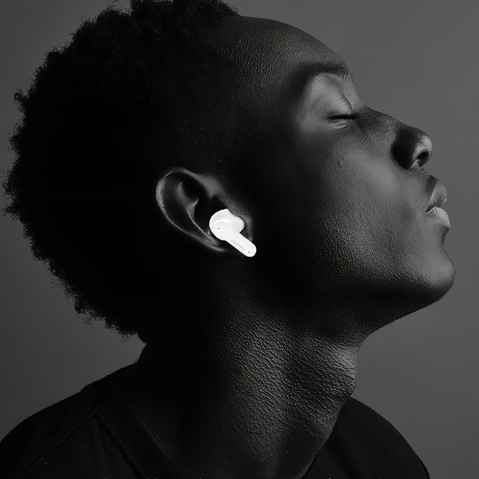Person wearing Keovy Translator Earbuds with a dark background