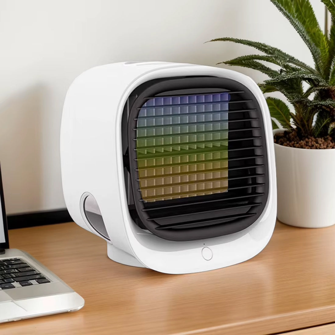 Small Coolevax Portable Air Conditioner on a desk with a laptop and plant in the background