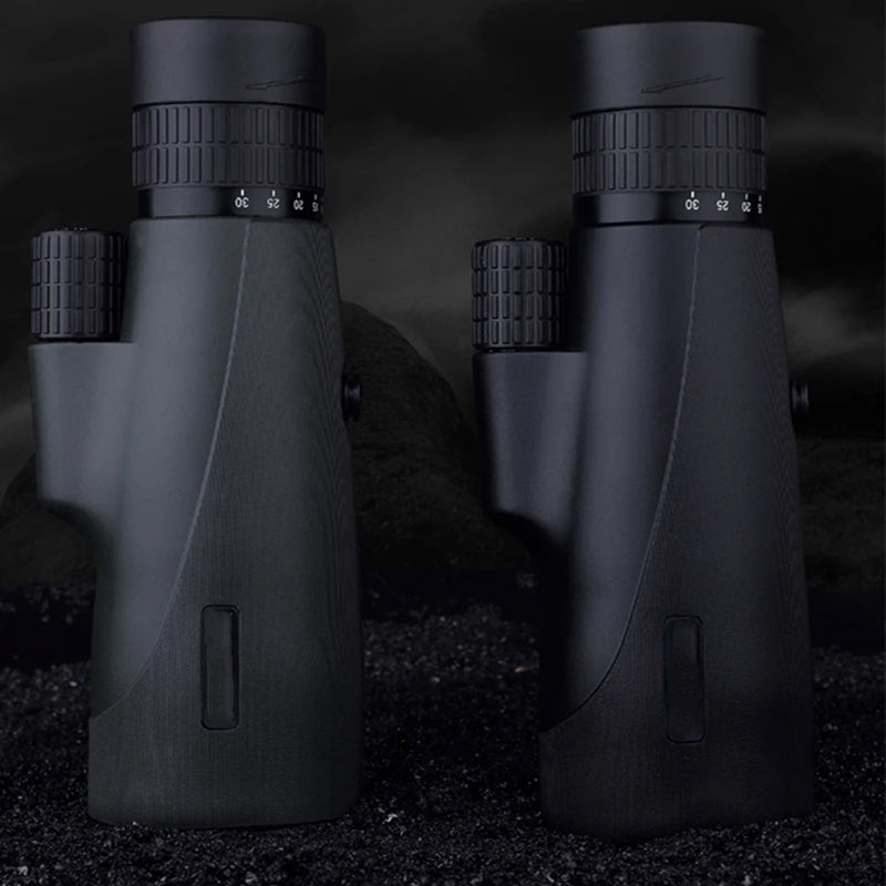 Two black SoceScope Monocular on a dark background