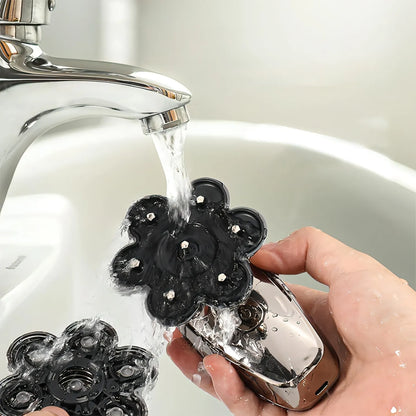 Person washing black Keovy Head Shaver flower-shaped objects under running water from a faucet.
