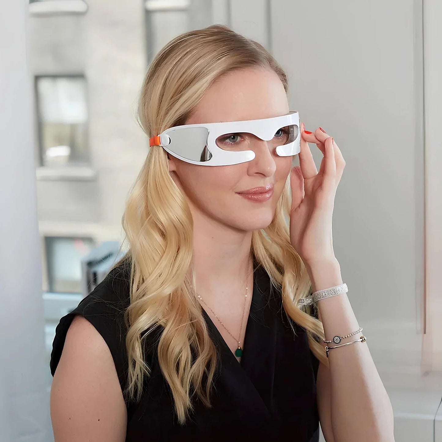 Woman wearing futuristic Eyviola Eye Massager in a modern indoor setting