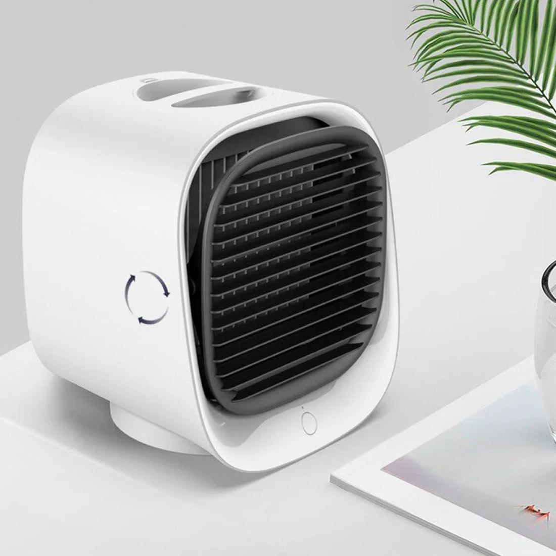White Coolevax Portable Air Conditioner on a light gray surface with a plant in the background