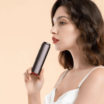 Woman holding a Vellera S1 Pro Facial Skin Tightening Device beauty device against a beige background